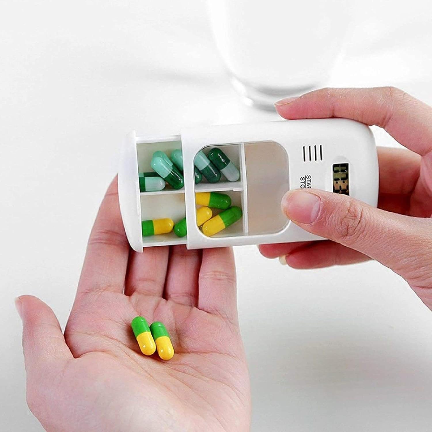 Someone is taking pills from a Portable Mini Travel Carry Pill Box
