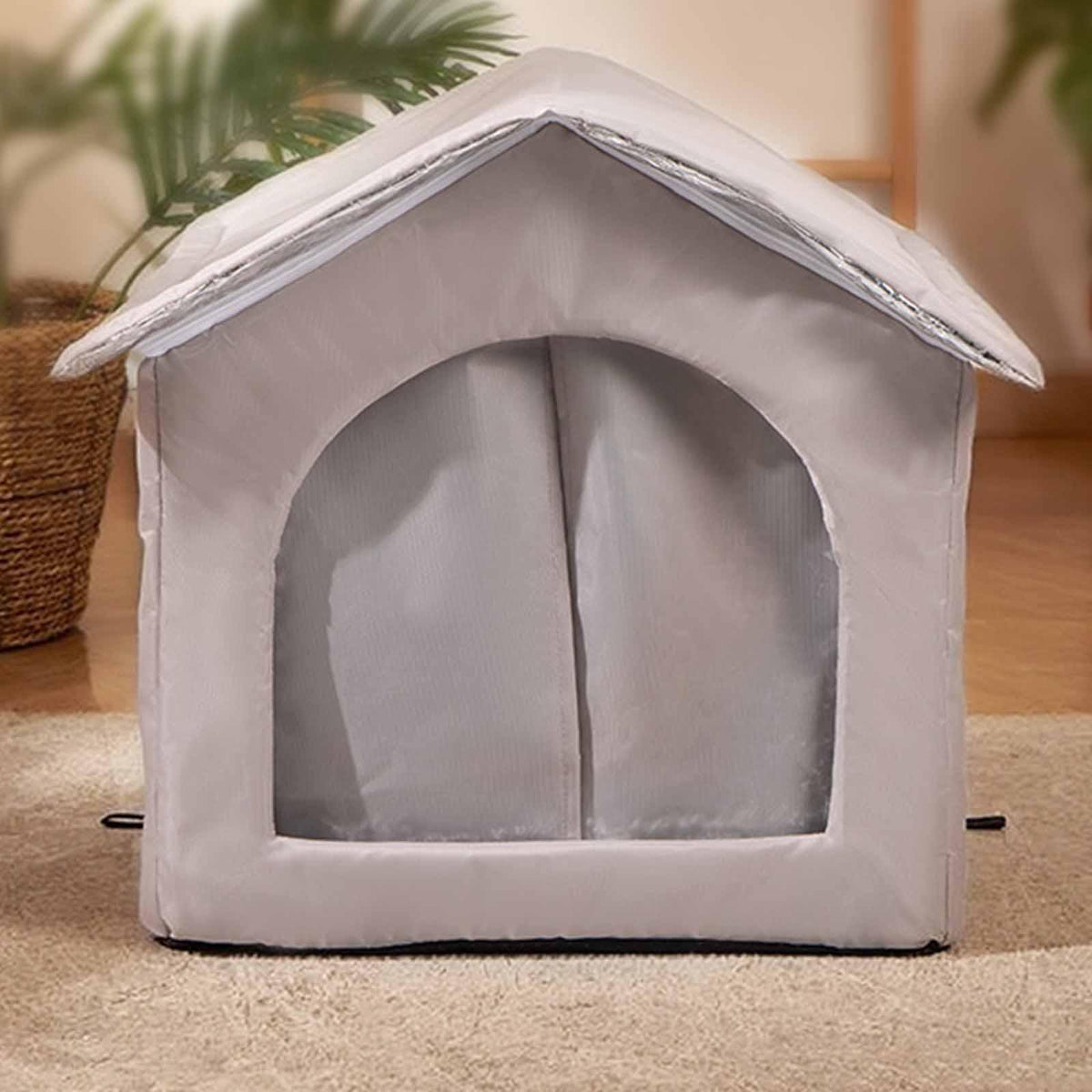 Gray pet house on a carpeted floor with plants in the background