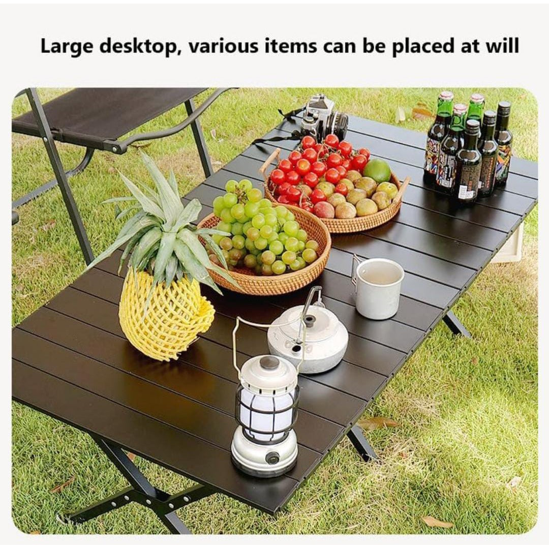 Outdoor Portable Camping Table being used on a picnic and some fruits,soft drinks and a jug placed on top of it