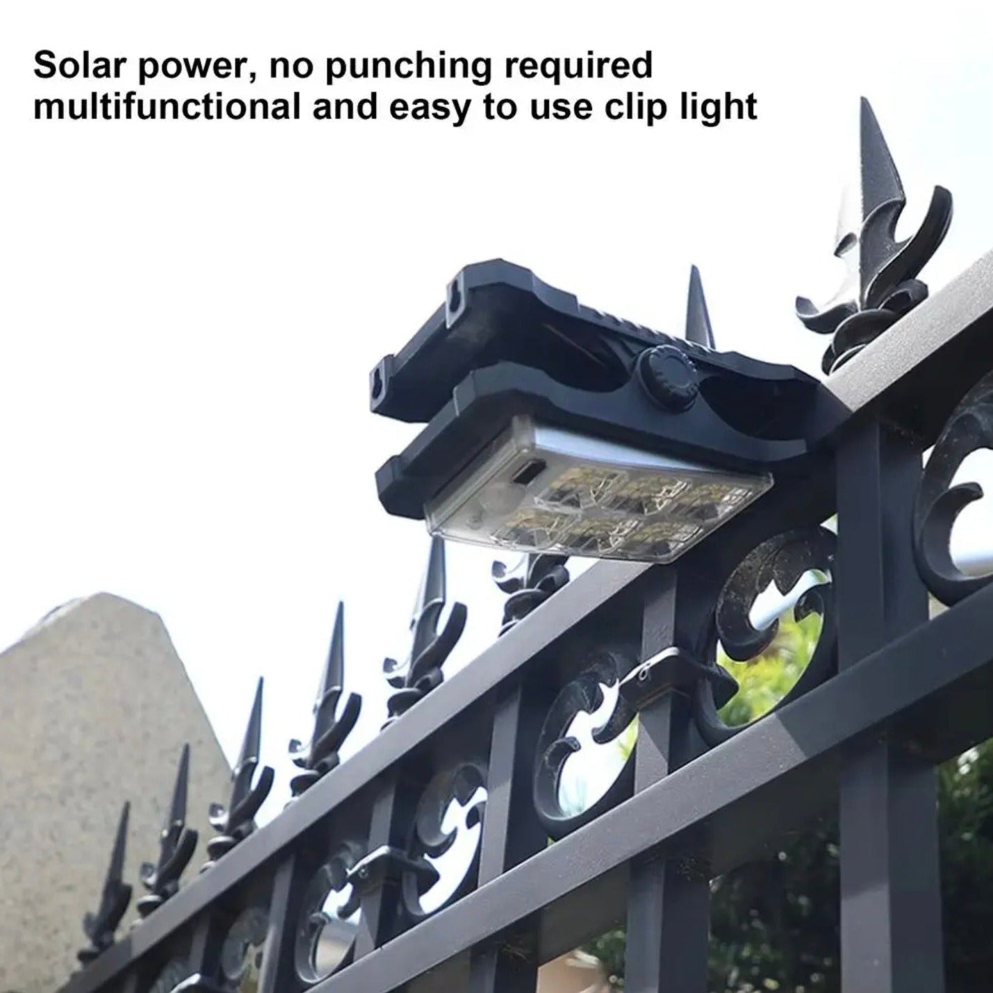 Outdoor solar clip lamp attached to metal fence.