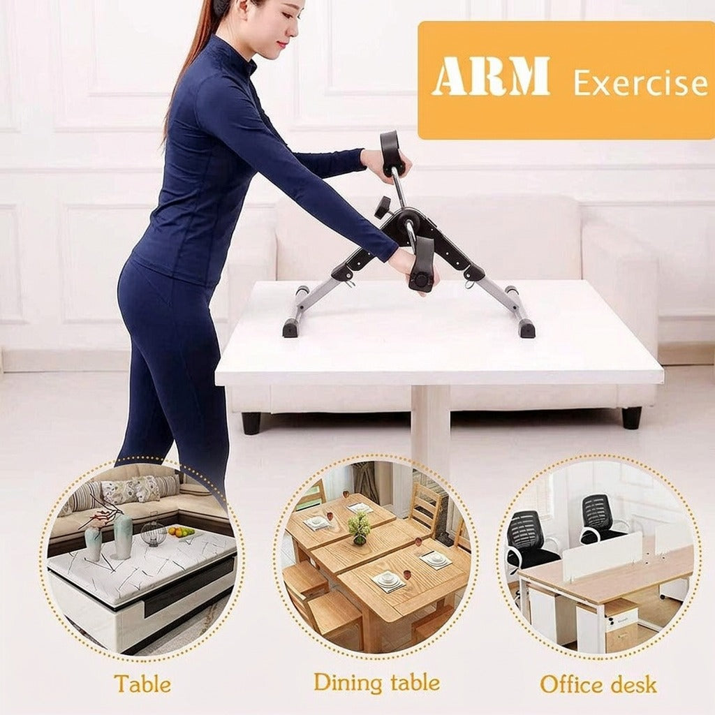 A woman is using a compact pedal exerciser placed on a table for an arm workout.