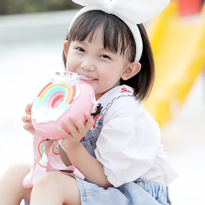 A Cute Is Drinking Water From a Donut-Shaped Kids Drinking Bottle.