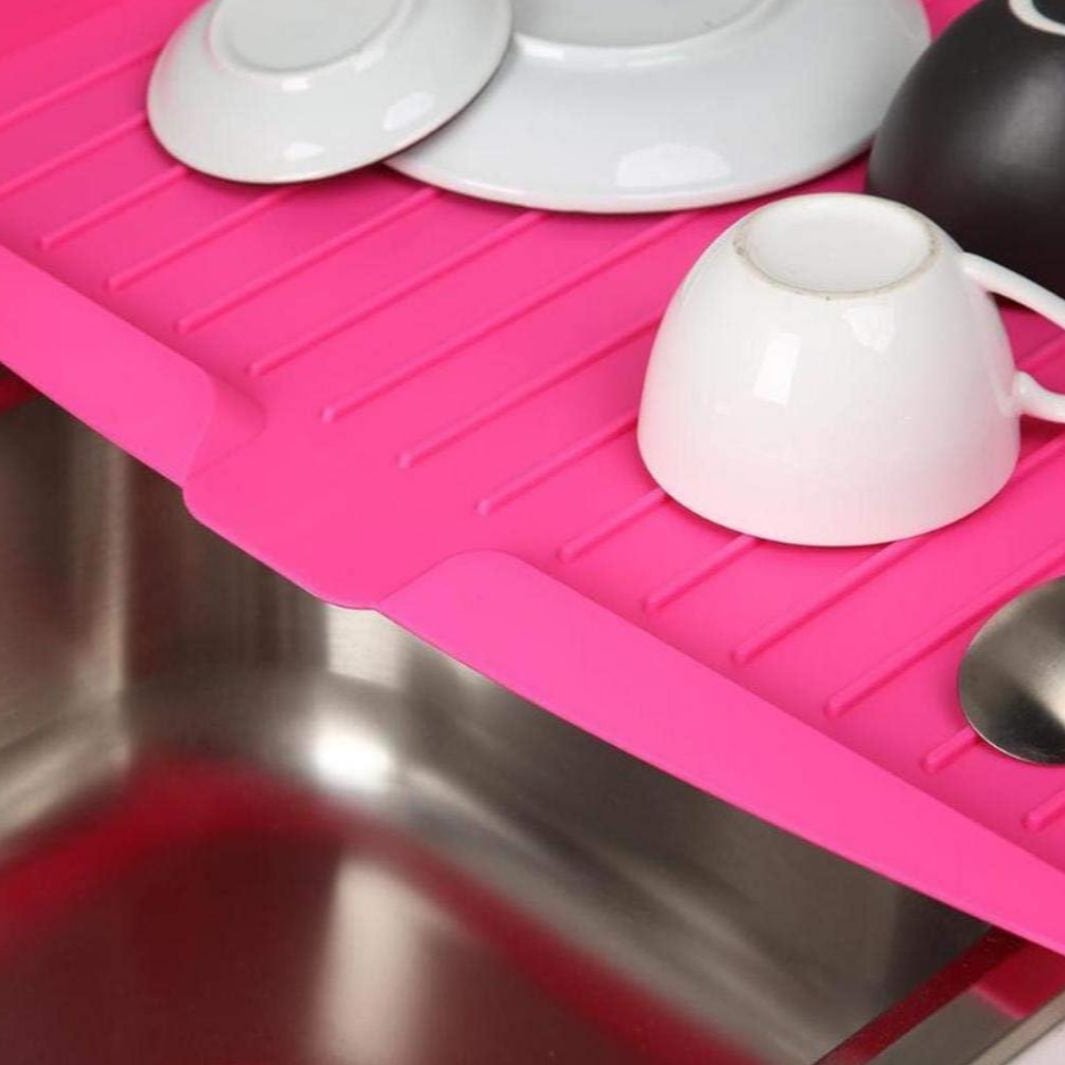 Utensils Are Placed On The Sink Dish Drainer Tray Rack.