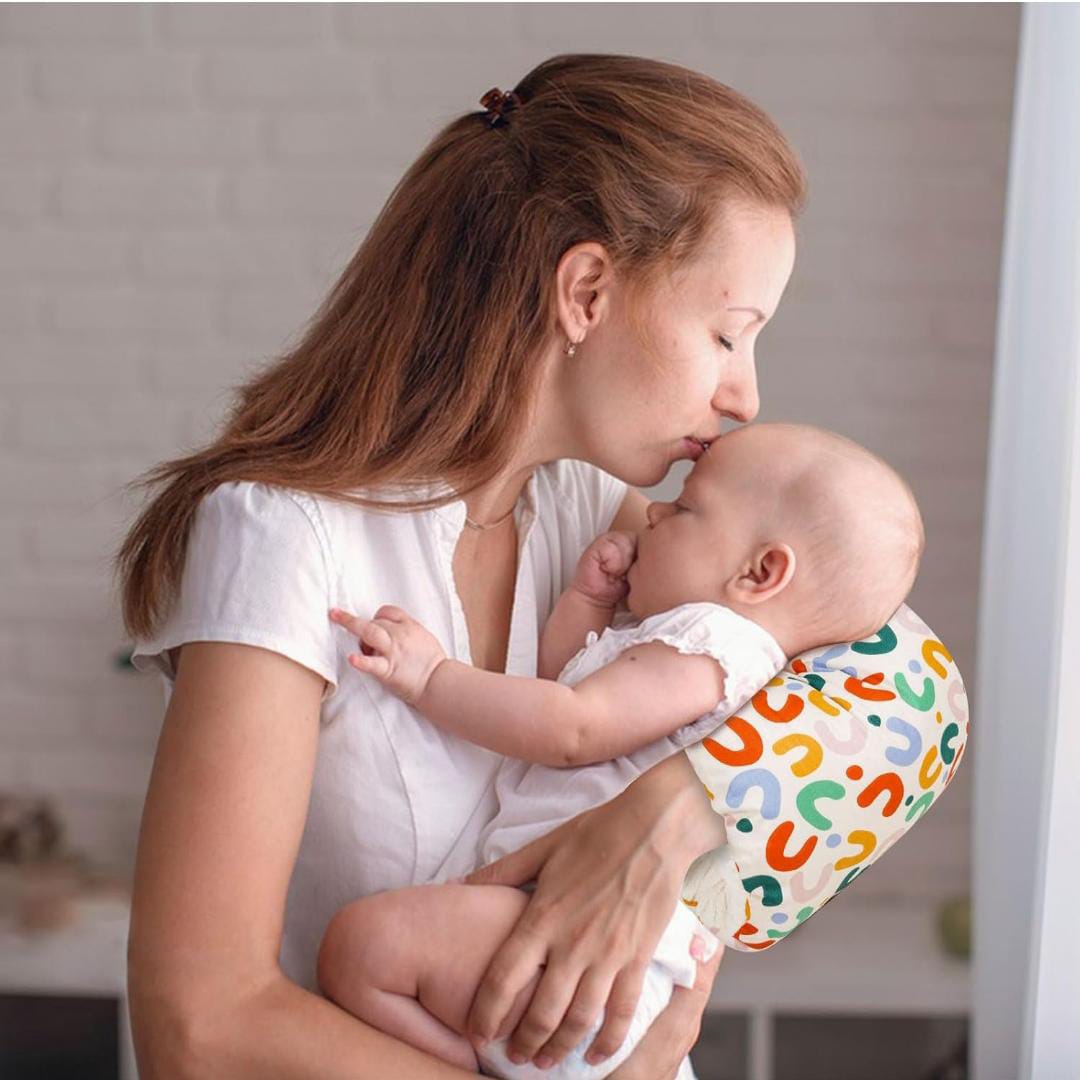 A Women is Holding Her Baby By Placing Nursing Arm Pillow On Her Hand.