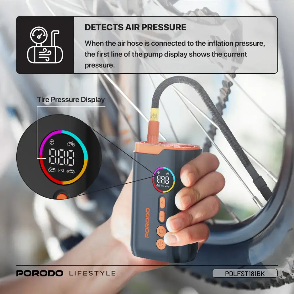 A Person is holding Porodo Lifestyle Electric Air Inflator which is connected to cycle tyre.