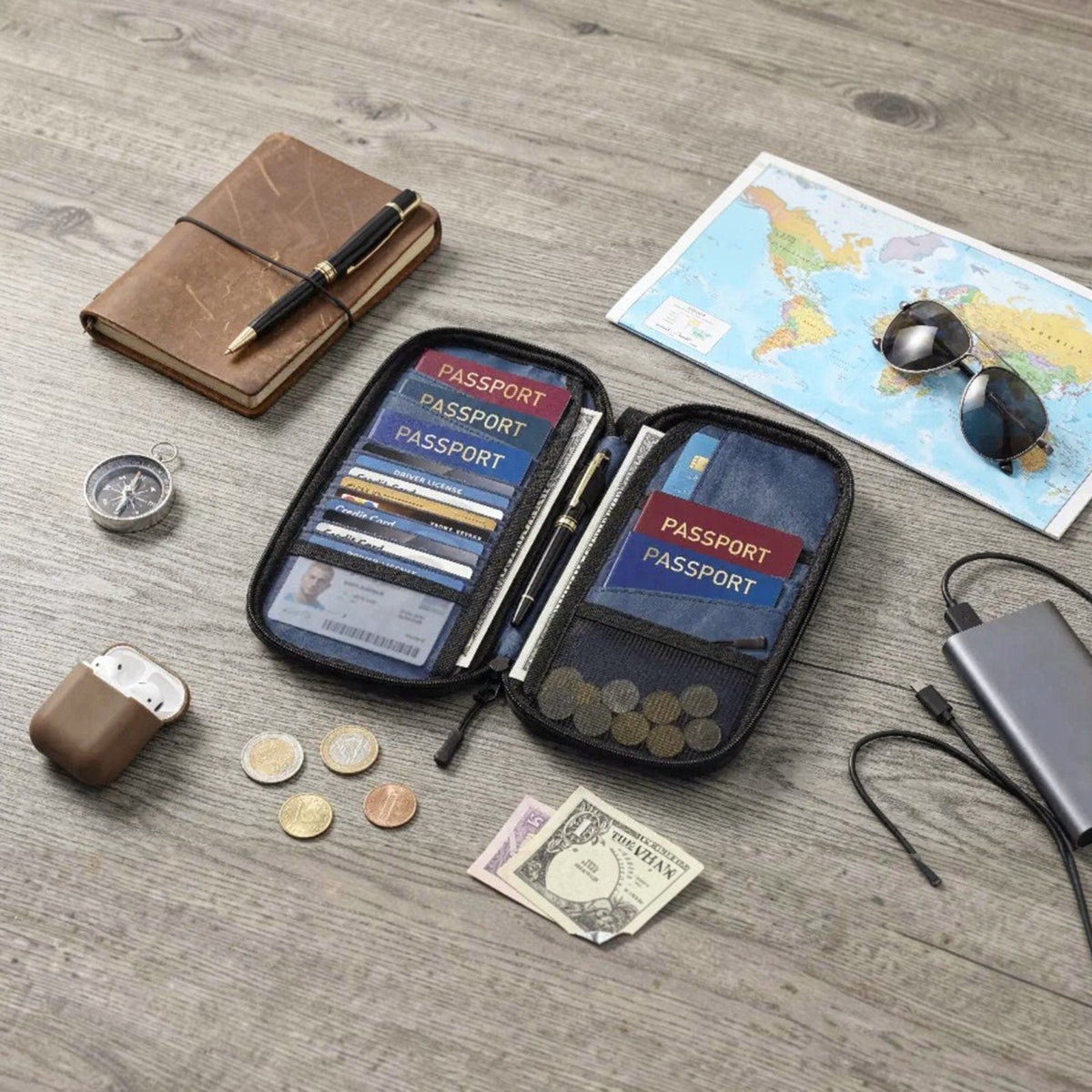 Porodo Milano Smart Passport Holder and cards on a wooden surface with a map and travel items.
