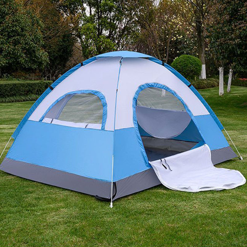 A Portable Camping Tent is Set Down in a Picnic Area.