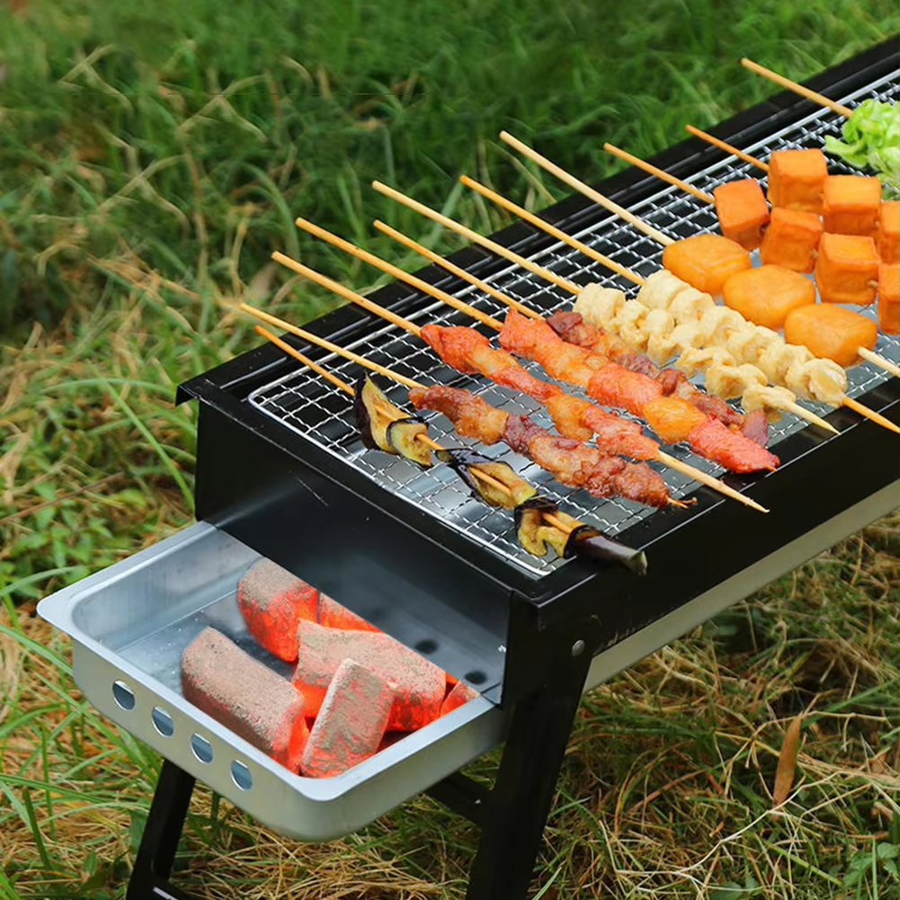 Chicken Meat are Placed on a Portable Charcoal Barbecue Grill.
