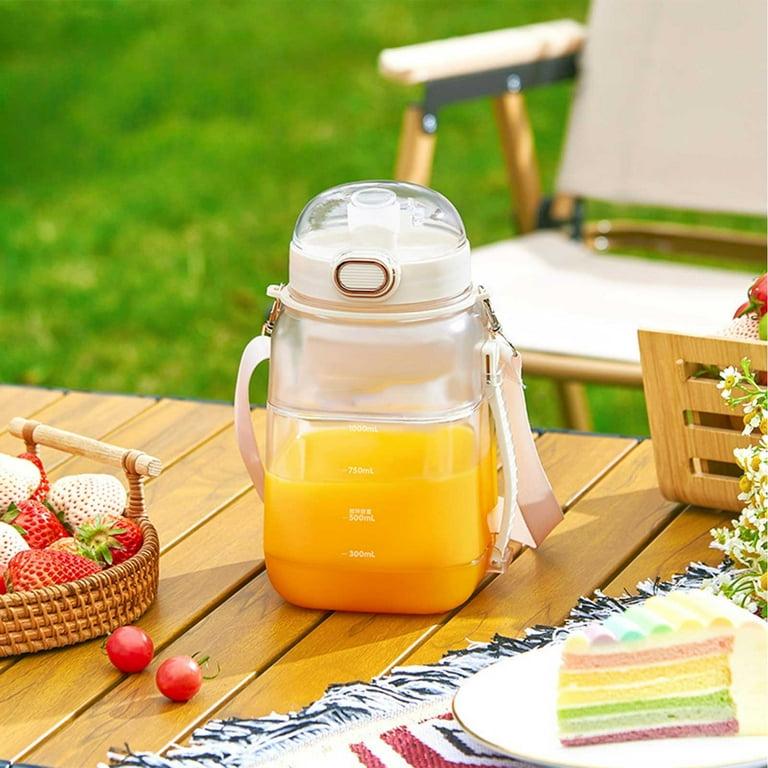 Portable Electric Juicer Blender Cup Filled With Juice.