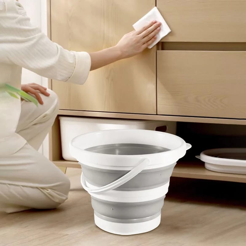 A Person is Cleaning Home Using Portable Folding Bucket.