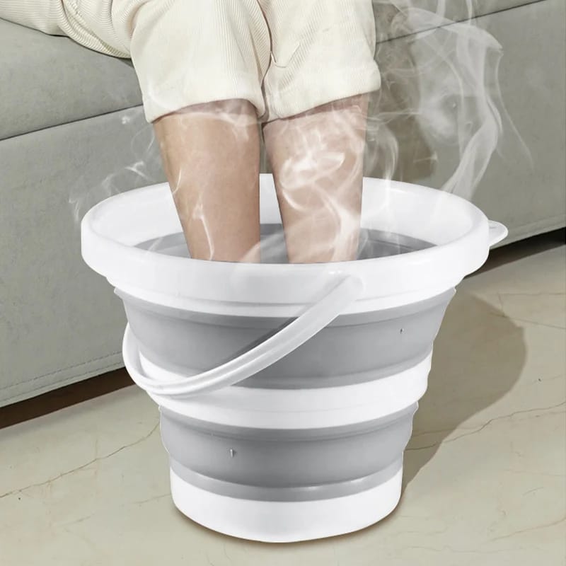 A Person is Pedicuring Leg Using Portable Folding Bucket.