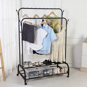 Clothing rack with clothes and shoes on a white background