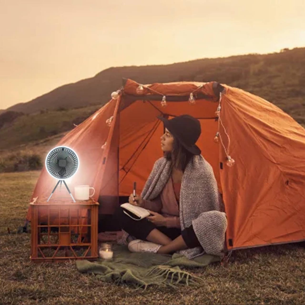 Portable Mini Fan is Placed Near Camping Tent By a Women.