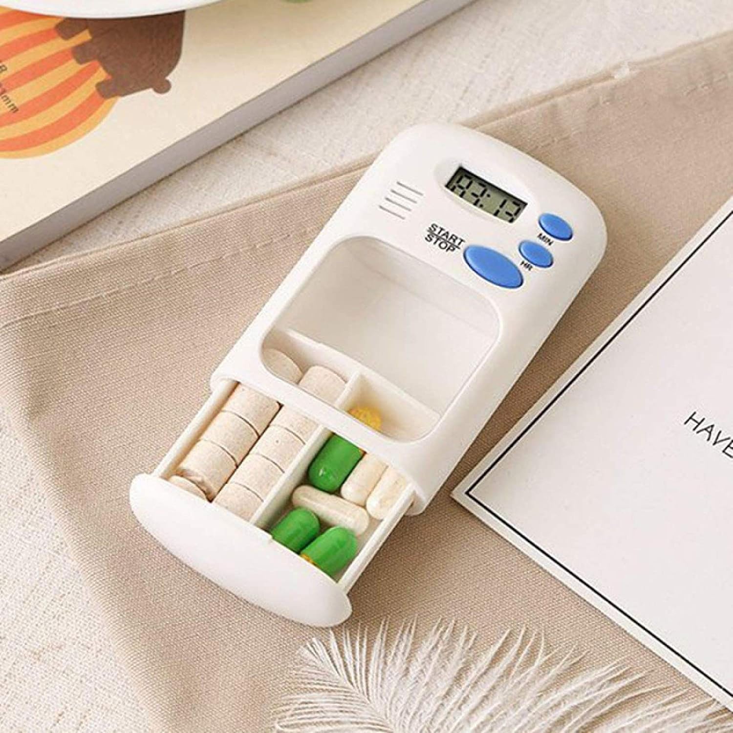The Portable Mini Travel Carry Pill Box is placed on the table
