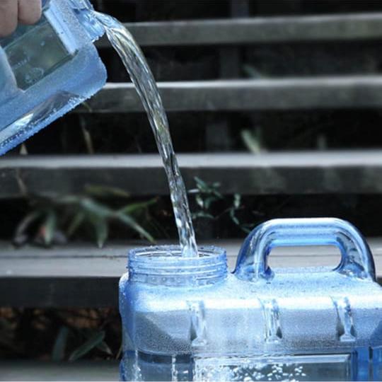 A Person is Filling Water in to Portable Water Tank Container Can.