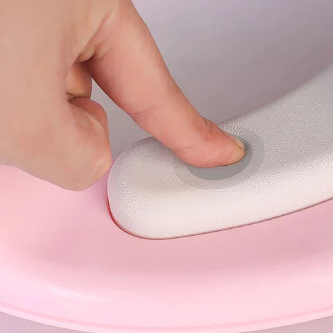 someone is pressing Potty Training Toilet Seat with Soft Cushion Handles