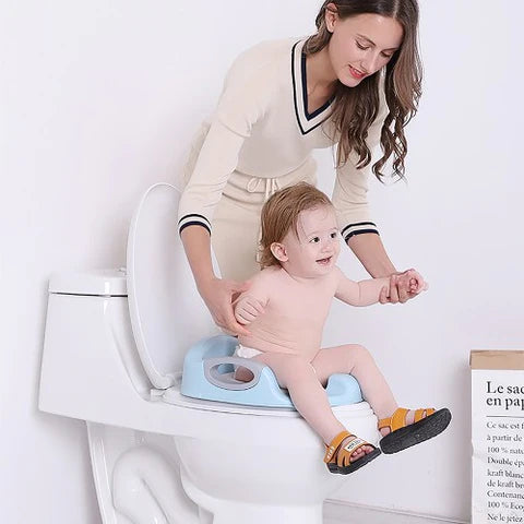 A mom is training her baby with a Potty Training Toilet Seat with Soft Cushion Handles