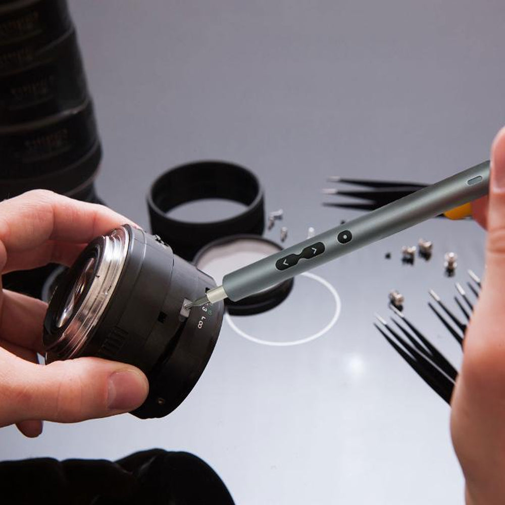 Someone repairing a camera lens using the Powerology Electric Screwdriver Kit