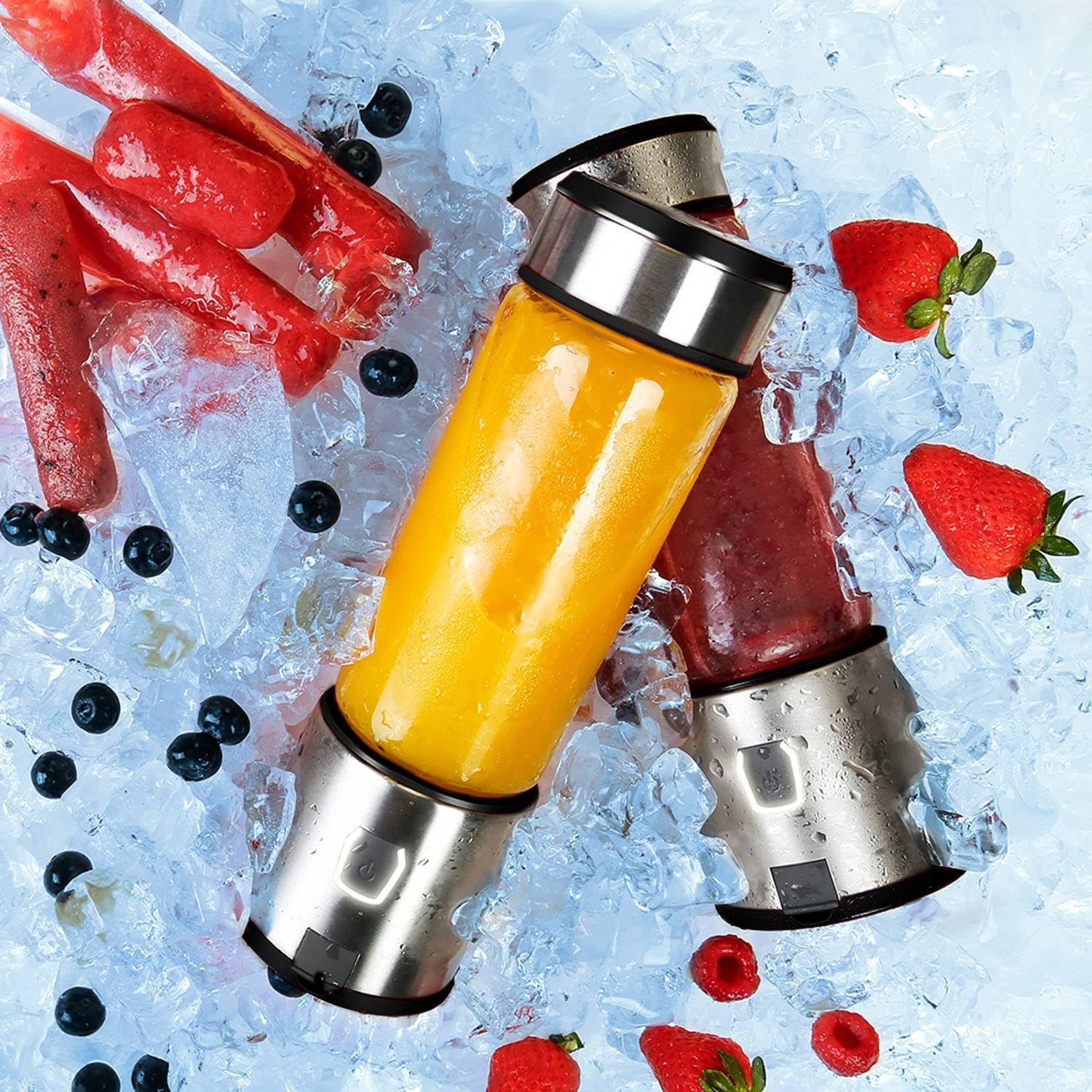 Two Powerology 6-Blade Portable Juicer filled with orange and red smoothies on a bed of ice and fruit.