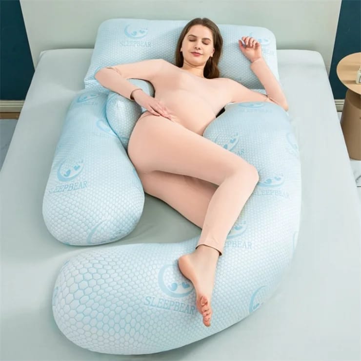 A Women is Lying On a Pregnancy Pillow.