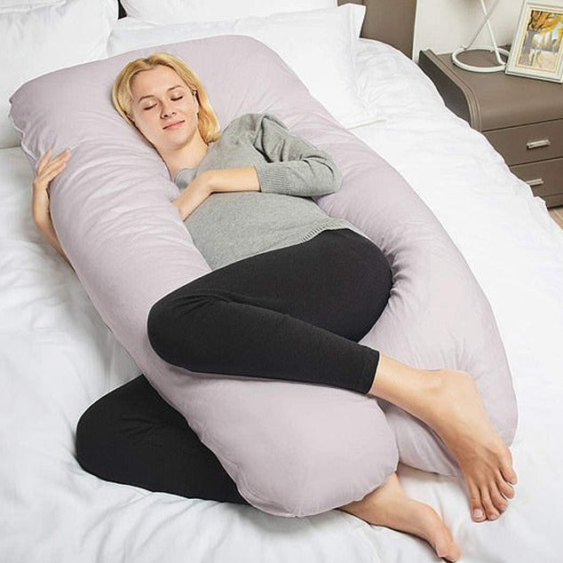Woman relaxing with maternity pillow