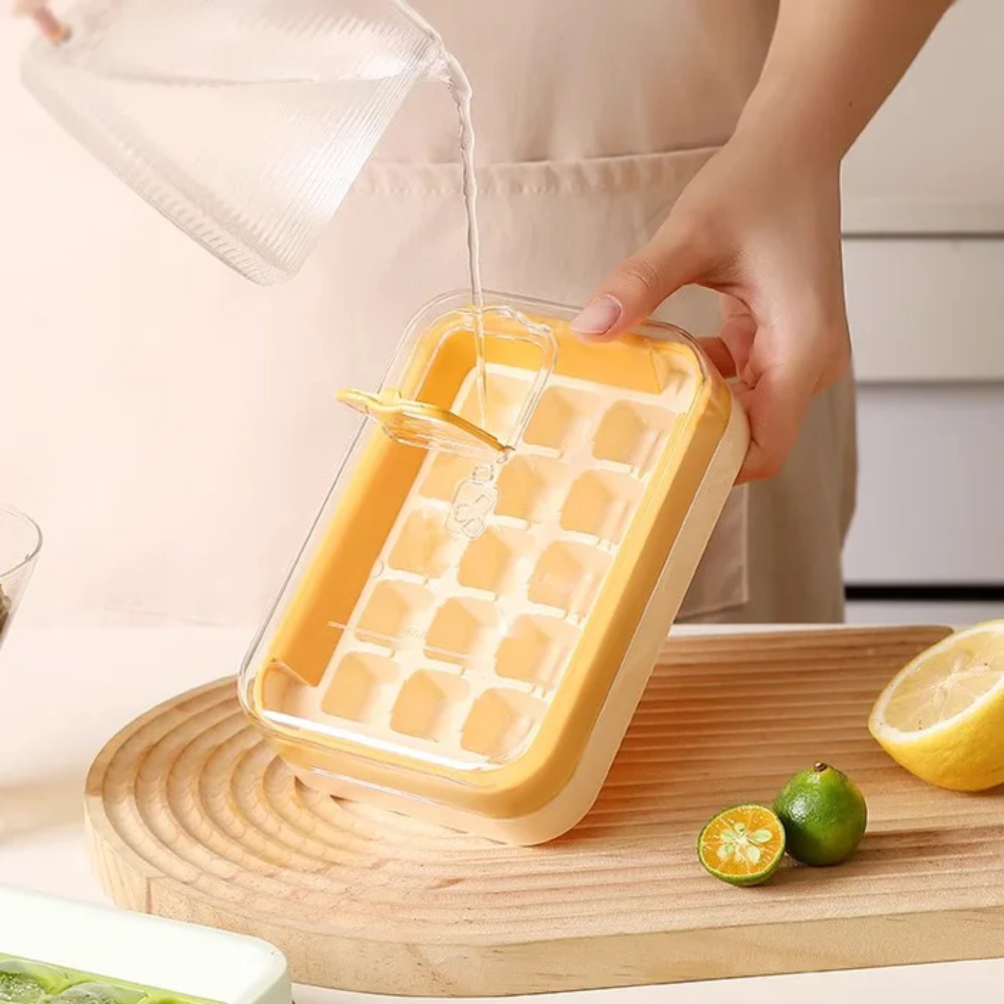 A Person is Pouring Water on to Press Type Ice Cube Making Tray Mold.