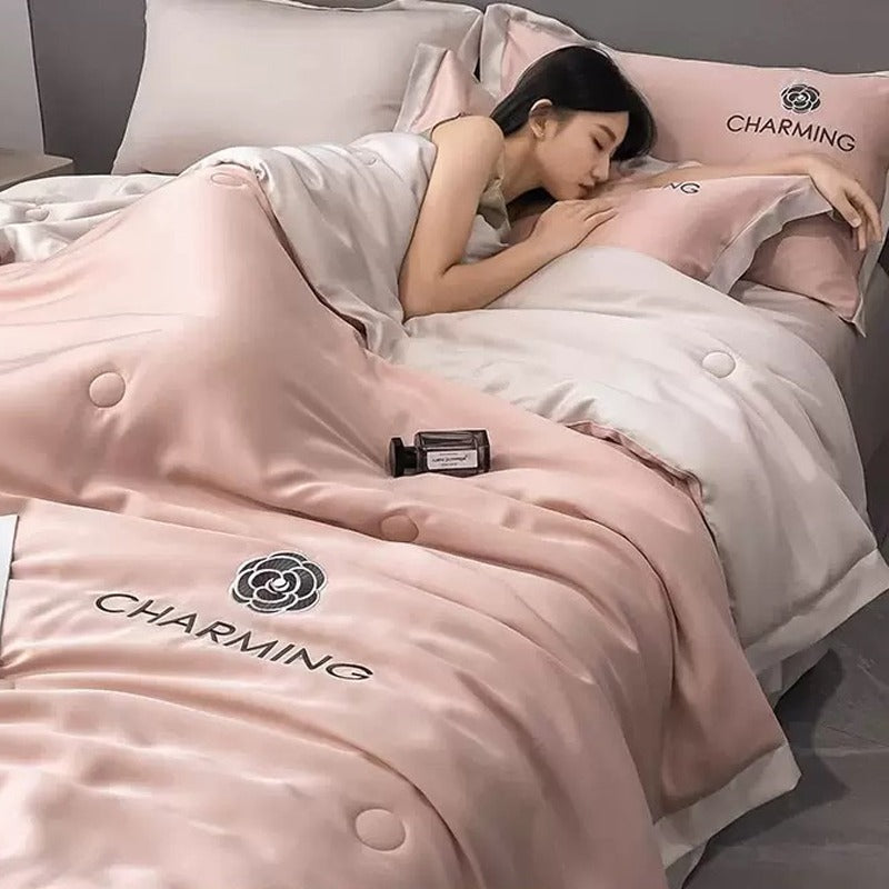 A Woman is Sleeping on Summer Quilted Cooling Comforter Bedding Set.