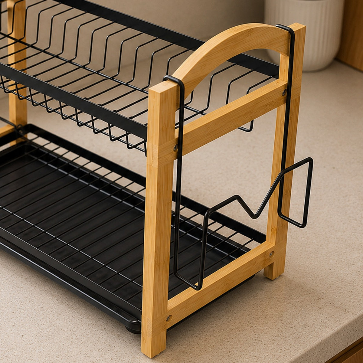 A two-tier kitchen dish rack with light natural wood frames and black metal wire shelves, shown on a beige countertop.