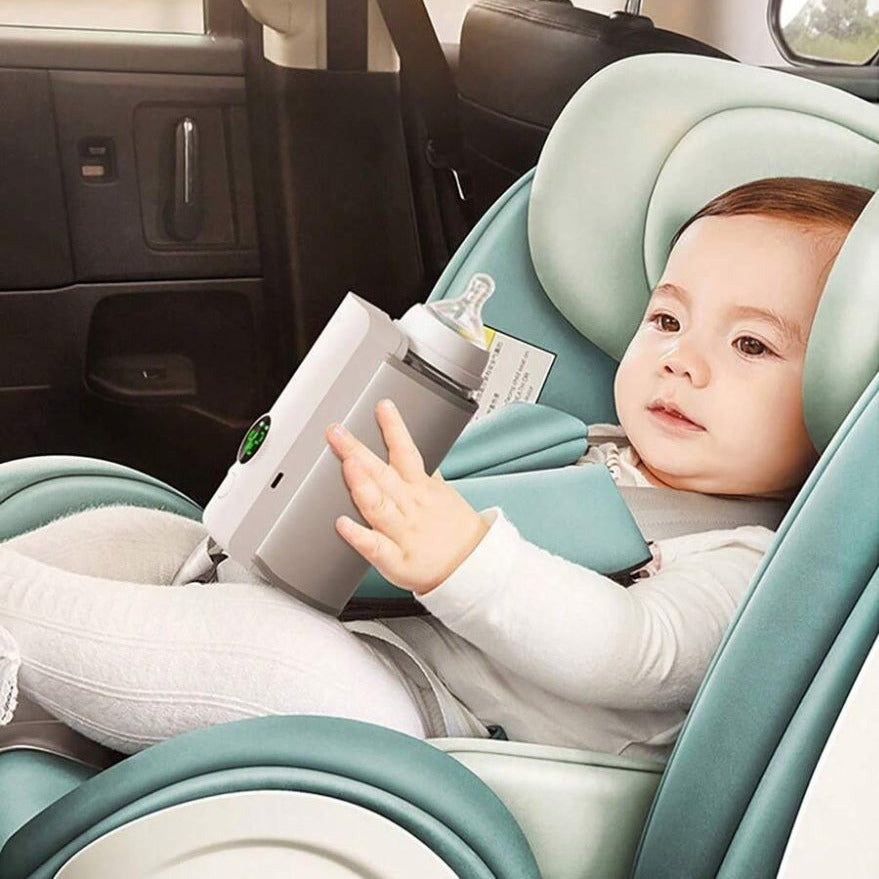 A Baby is Holding Rechargeable Portable Baby Bottle Warmer While Sitting inside a Car.