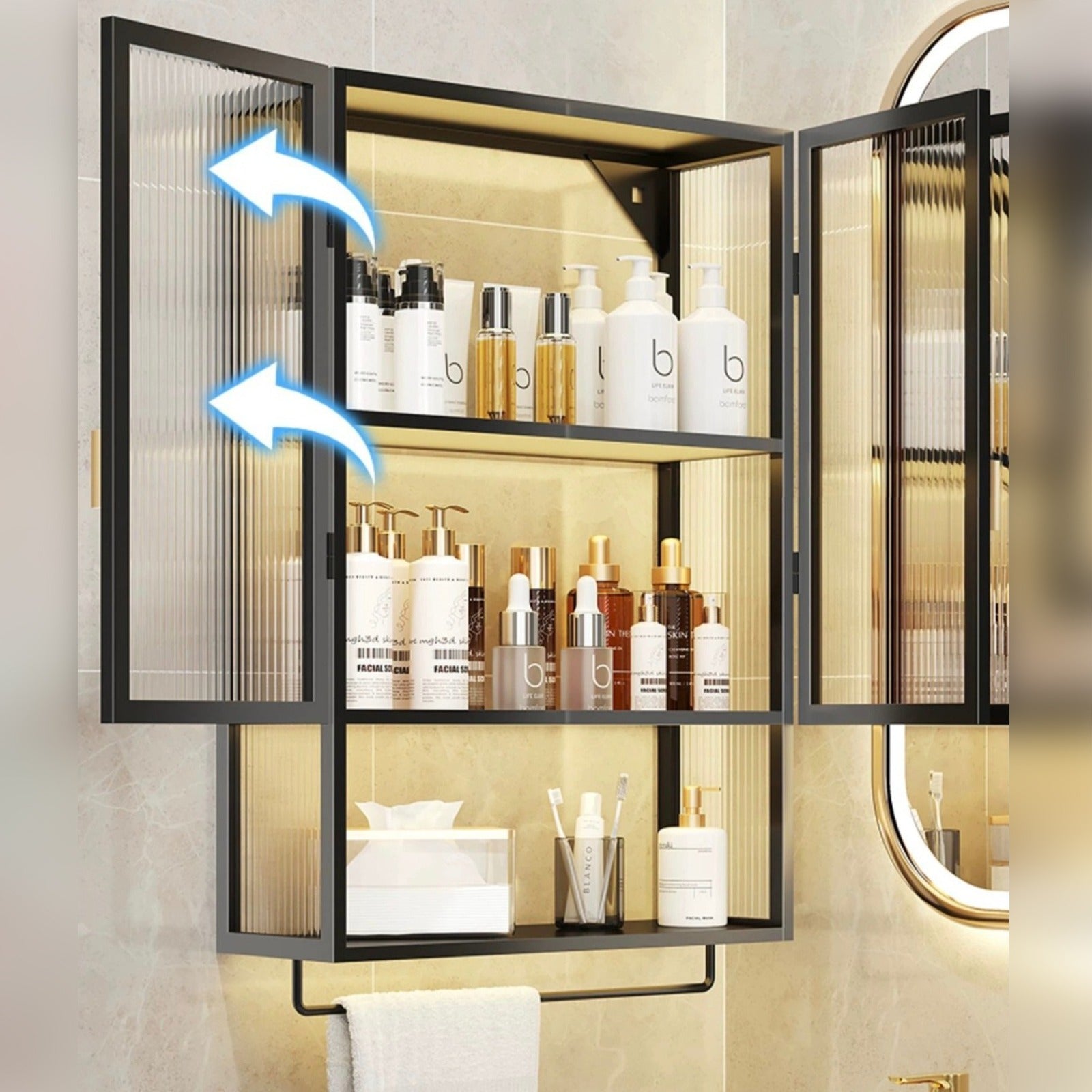 Wall-mounted storage organizer with ribbed glass doors, displaying neatly arranged bottles and cosmetics, and an open lower shelf holding folded towels