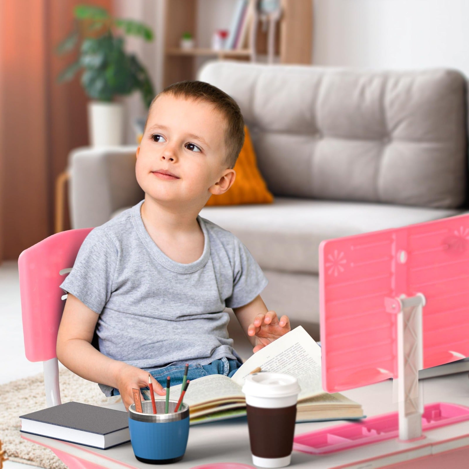 A Child is Studying by Sitting On a Adjustable Kids Study Table and Chair Set .