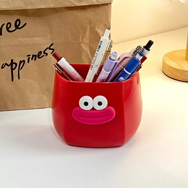 Cute cartoon-style desk organizers with smiling faces, used to hold pens, stationery, and small items, adding a fun and playful touch to any workspace.