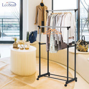 A Double Pole Portable Garment Rack Organized with Clothes.
