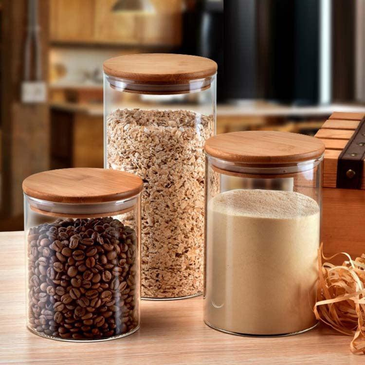 A Set Of Glass Storage Jars  are Filled Essential Food Items.