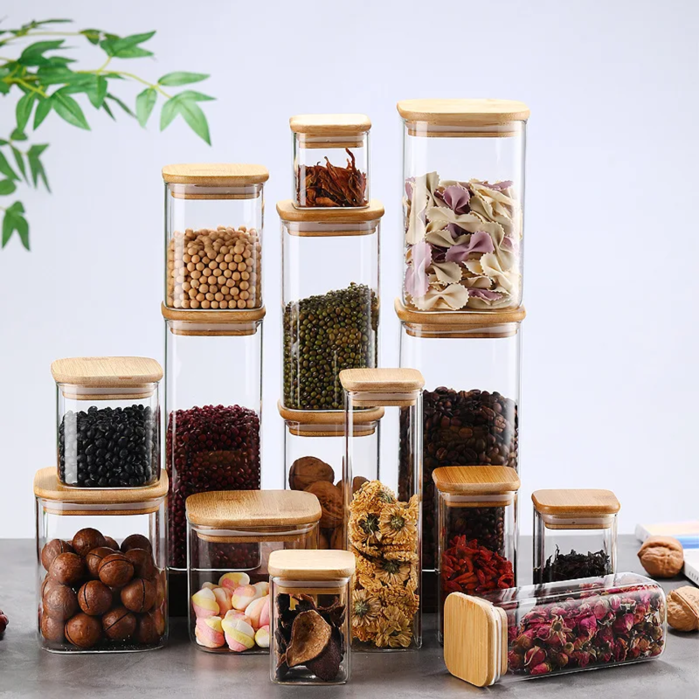 A Set Of Glass Storage Jars  are Filled with Snacks and Other Food Items.