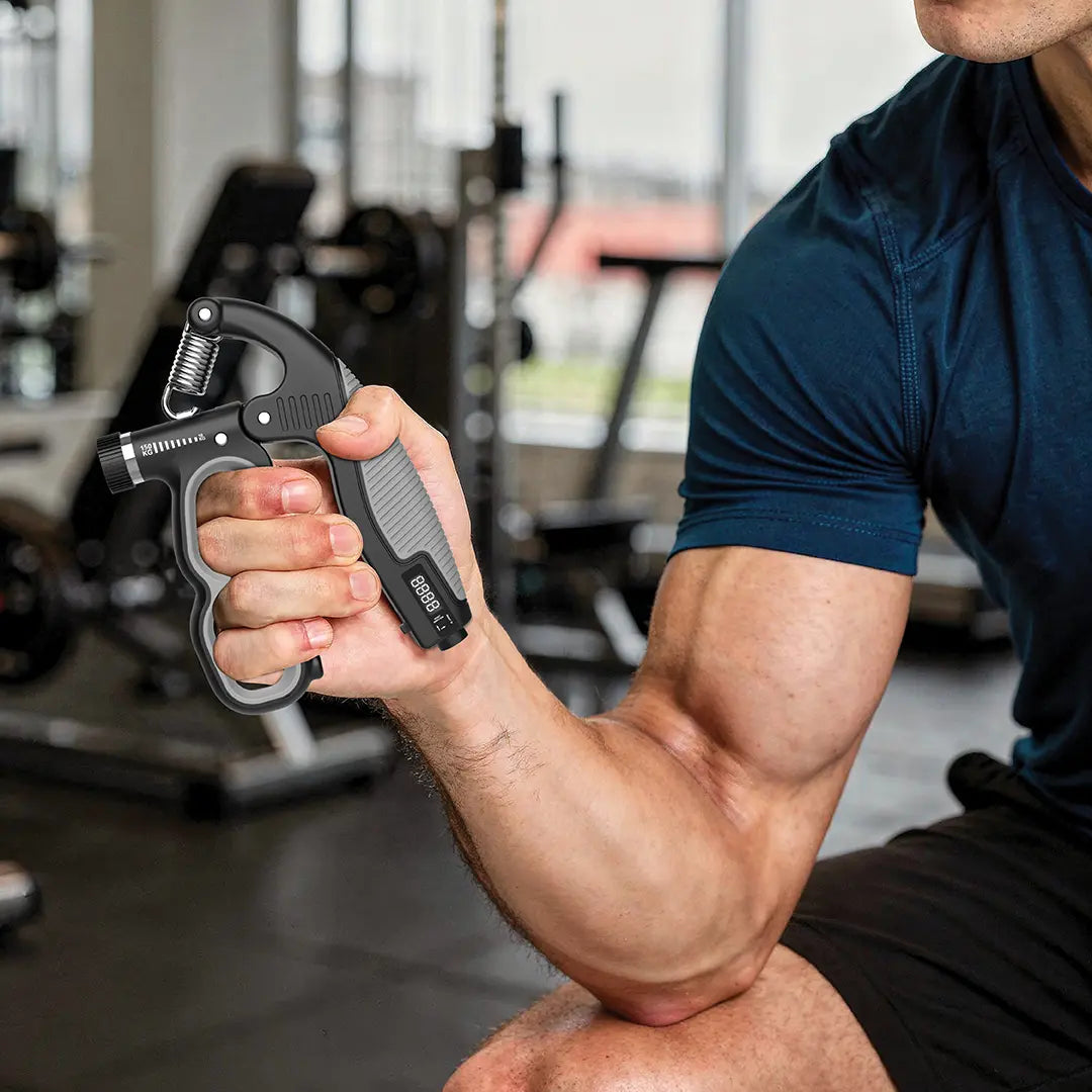 Person using a Green Lion Grip Force Hand Grip Strengthener in a gym setting