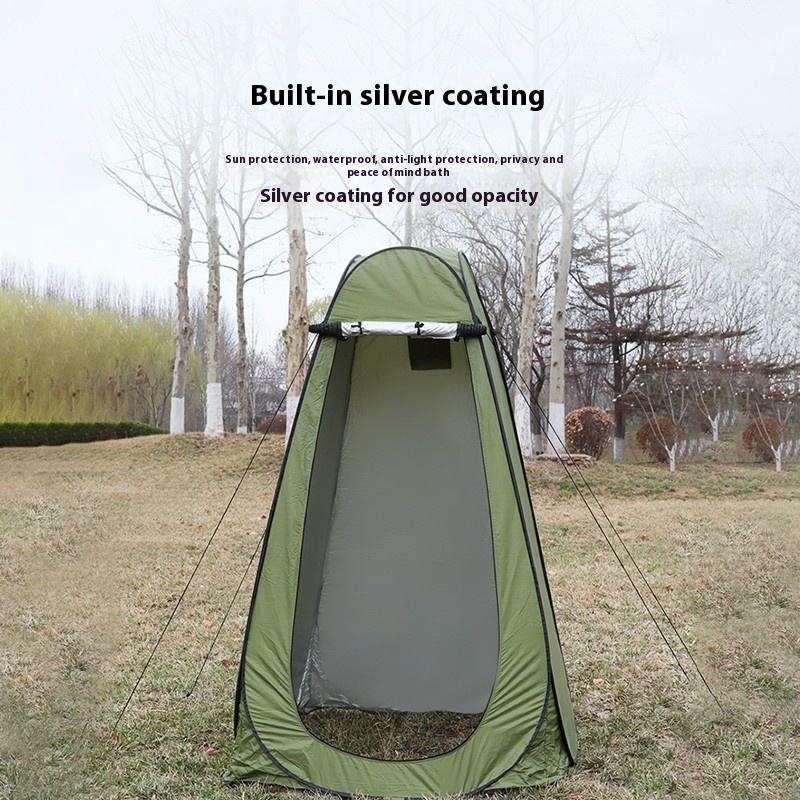 Green pop-up privacy tent for outdoor camping, designed for changing clothes, showering, or toilet use in the forest.