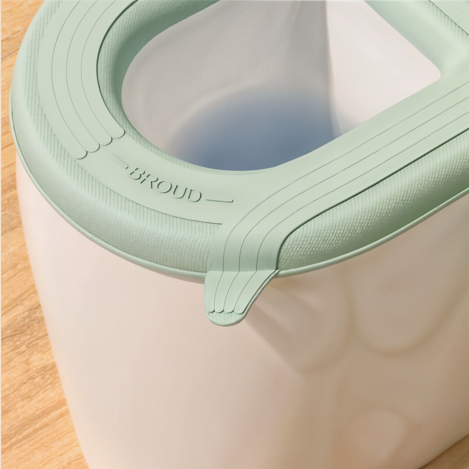 A padded toilet seat cover shown fitted on a toilet.