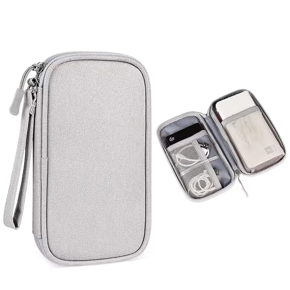 Gray travel organizer with clear lid showing electronic devices on a white background