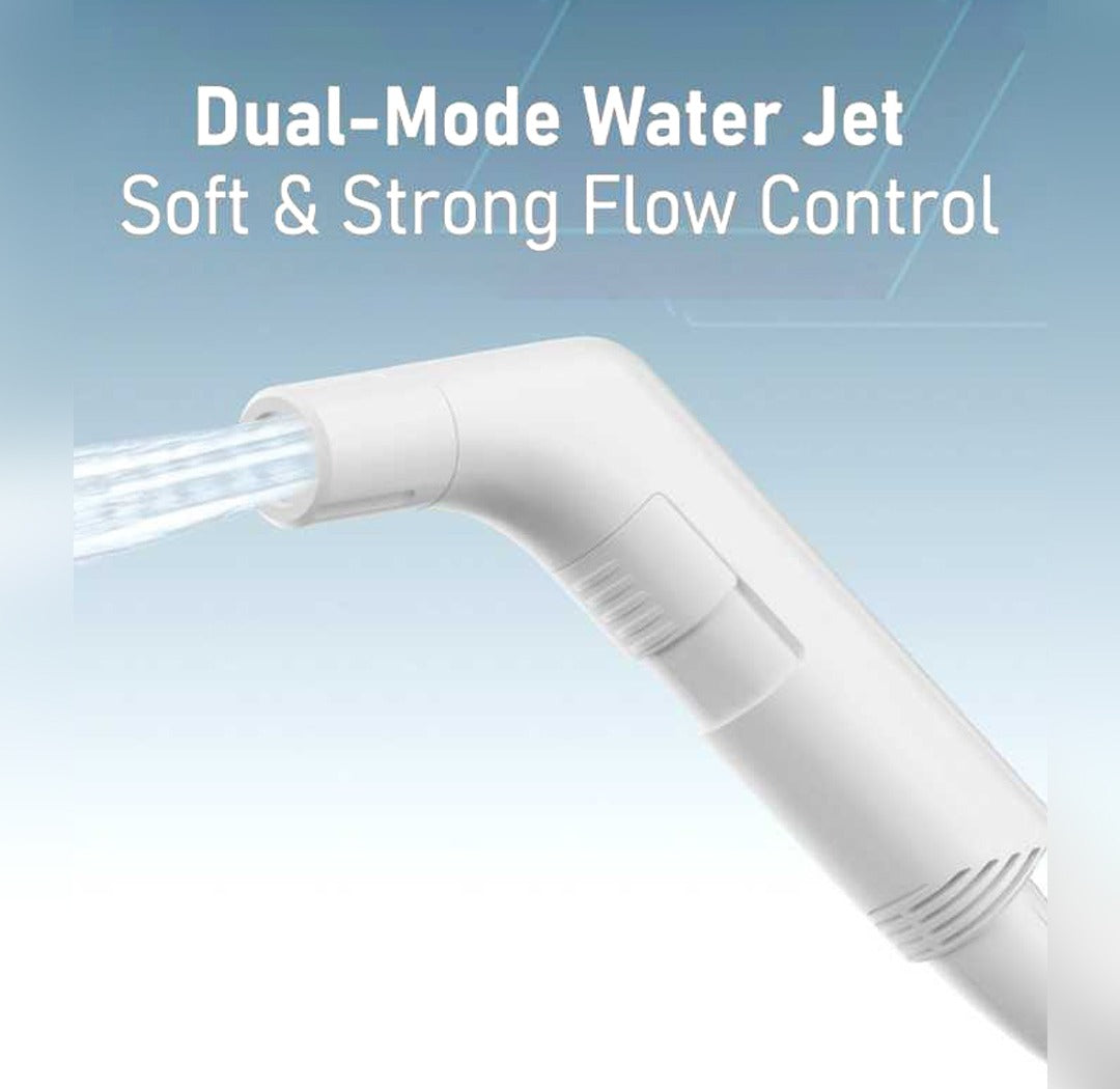 A Moxedo JetStream Portable Electric Bidet Sprayer shown at an angle with a stream of water flowing from the nozzle. The background is a soft light blue gradient with white text reading 'Dual-Mode Water Jet' and 'Soft & Strong Flow Control'.