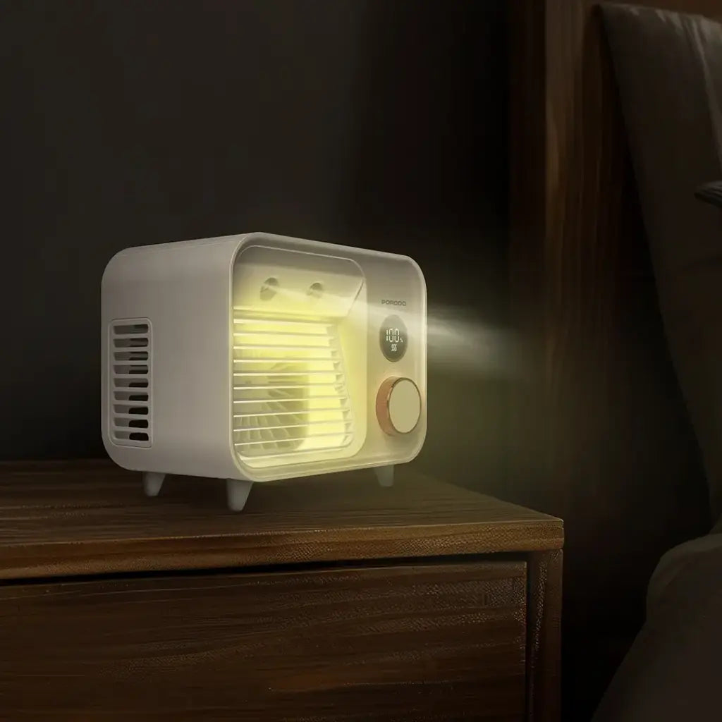 White Porodo Mini Mist Fan Desktop Air Cooler emitting light on a wooden surface with a dark background