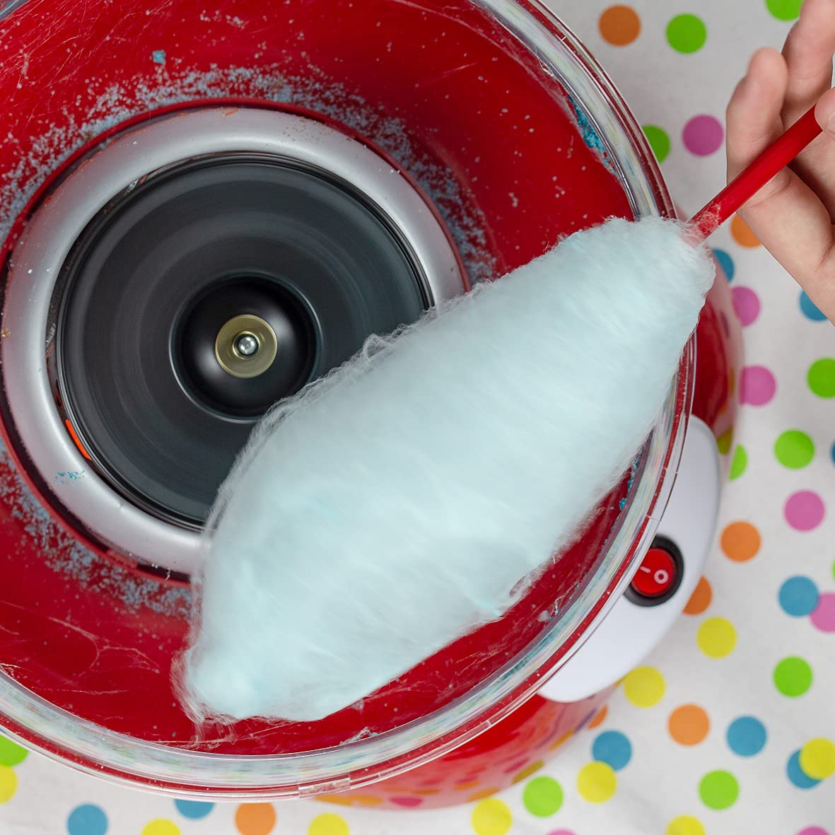 A Person is Making Candy Using Cotton Candy Maker.