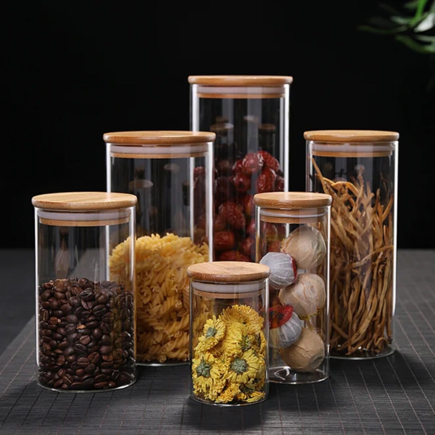 A Set Of Glass Storage Jars  are Filled with Spices.