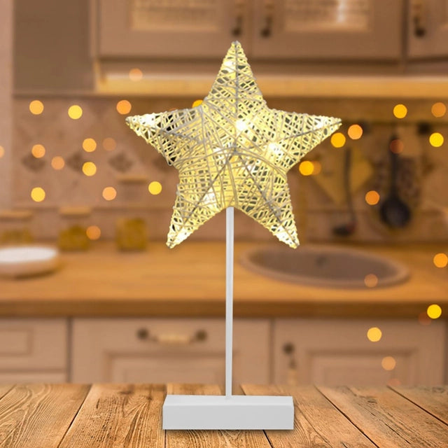 A LED Star Table Lamp Decorative Night Light is Placed on a Table.