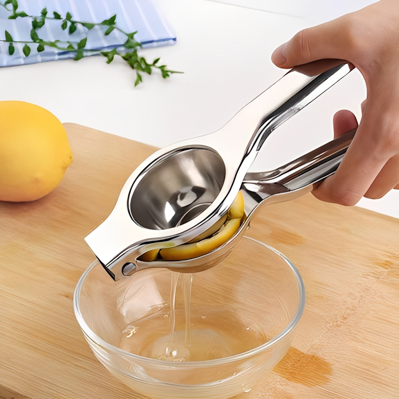 A Person is Squeezing Lemon Using Stainless Steel Lemon Squeezer.