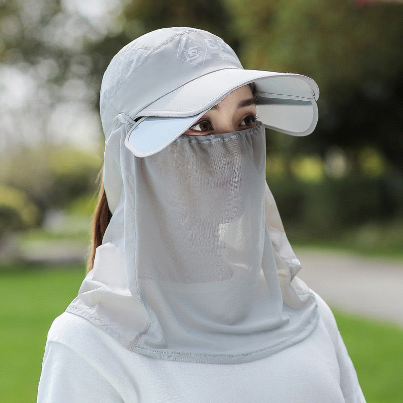 A Woman is Wearing Wide Brim Bucket Hat with Neck Cover.