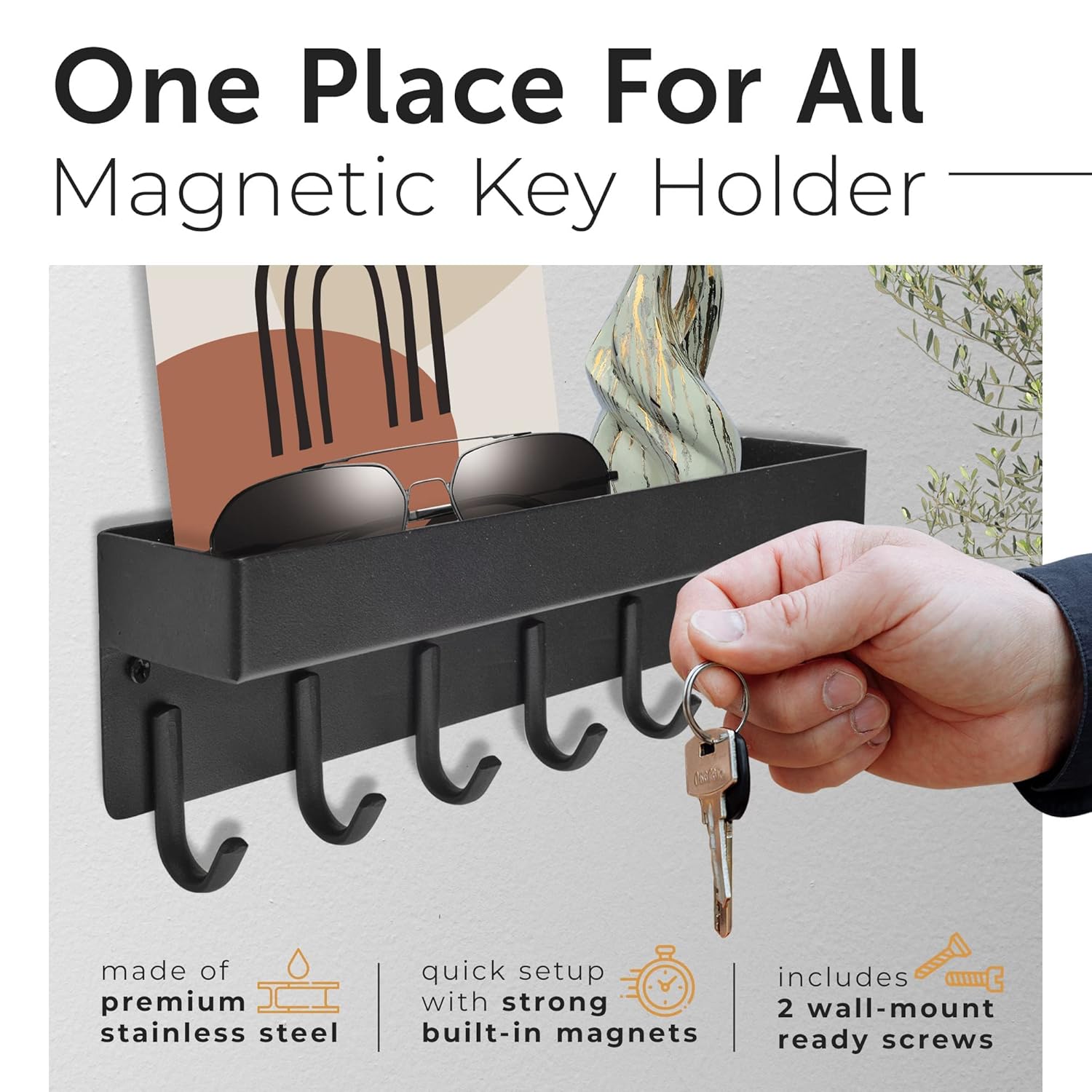 A Person is hanging Key on a wall-mounted key holder.