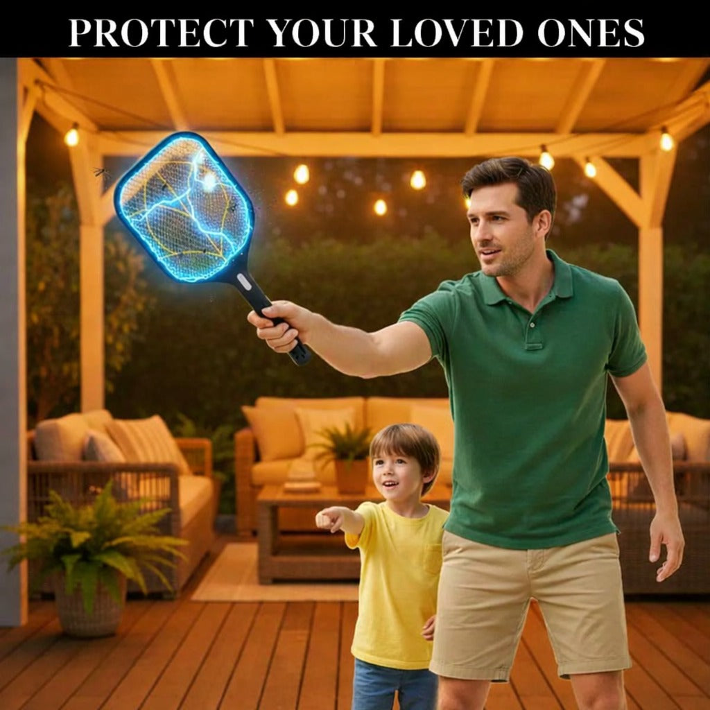 A man is standing outdoors on a cozy, well-lit patio at night, holding a Gecko electric mosquito racket that is visibly glowing with electric current. A young child stands beside him, pointing ahead with excitement.