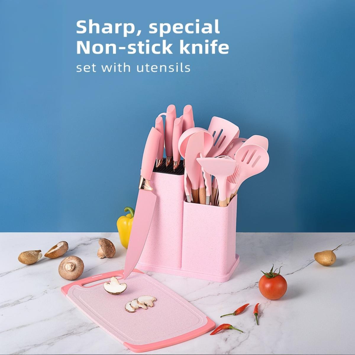 18-piece silicone kitchenware set in a holder including spatulas, ladle, tongs, whisk, pasta server, brushes, and scissors, neatly organized on a kitchen countertop.