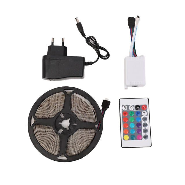 LED strip light kit with power adapter, remote control, and connectors on a white background
